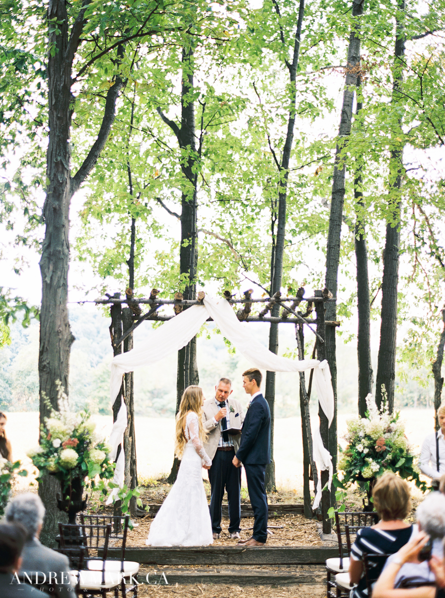 Bride and Groom standing under pulpit